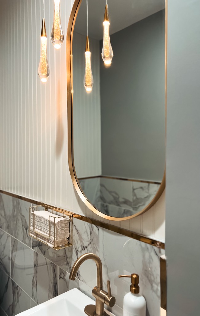 Makeup vanity with gold mirror and lighting